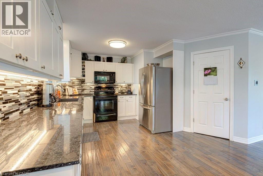 Kitchen featuring wood-finish flooring and white cabinetry - 61 Ditner Avenue, Baden, ON - Indoor Photo Showing Kitchen With Upgraded Kitchen