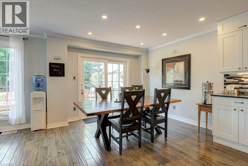 Dining area featuring wood-finish flooring, recessed lighting, and a sliding glass door to the exterior - 61 Ditner Avenue, Baden, ON - Indoor Photo Showing Dining Room