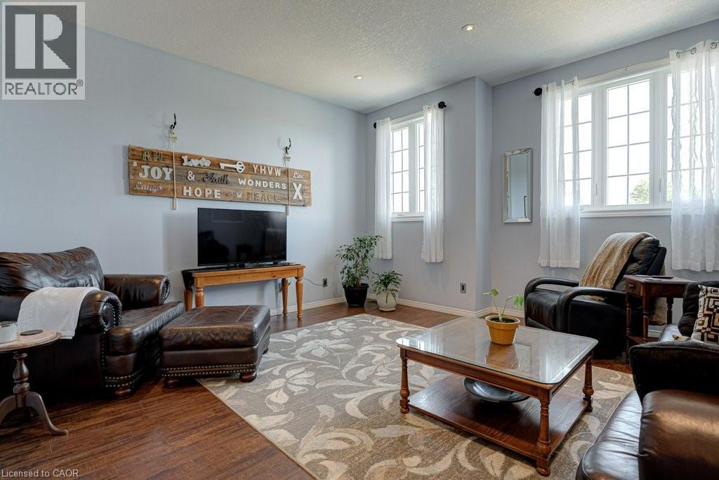 Living area featuring wood-finish flooring, light grey walls, white trim, and recessed lighting - 61 Ditner Avenue, Baden, ON - Indoor Photo Showing Living Room