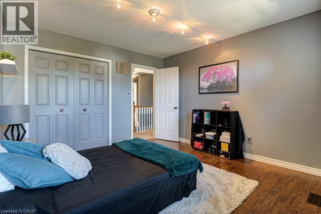 Room featuring wood-finish flooring, neutral gray wall tones, and recessed ceiling lighting - 61 Ditner Avenue, Baden, ON - Indoor Photo Showing Bedroom