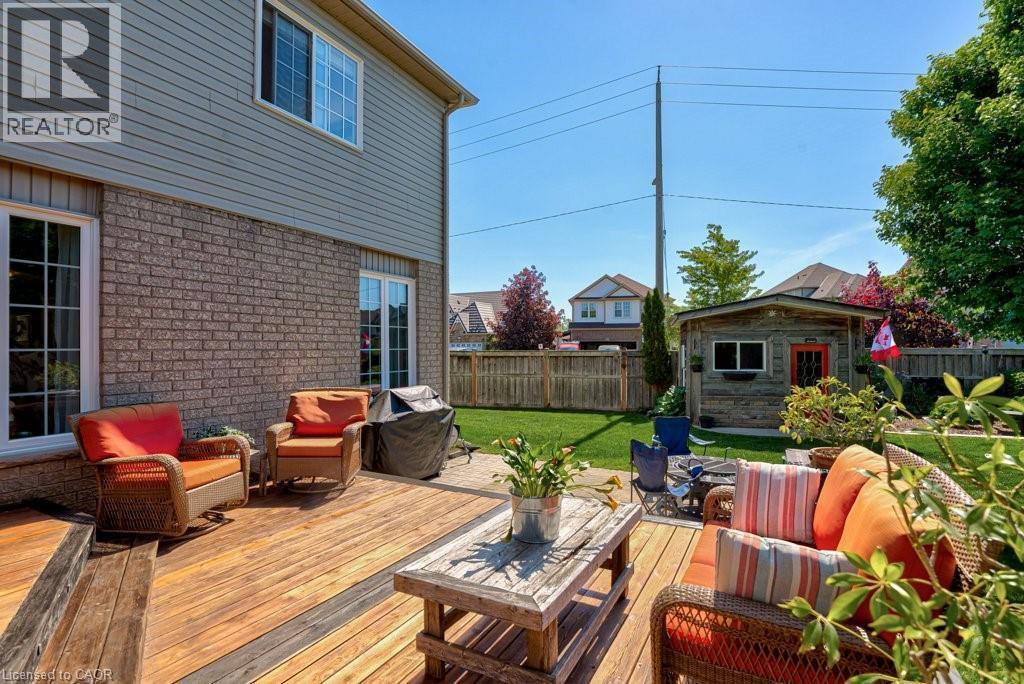 Expansive backyard featuring a wood deck with multiple steps, a manicured lawn, a detached shed, and mature trees - 61 Ditner Avenue, Baden, ON - Outdoor With Deck Patio Veranda With Exterior