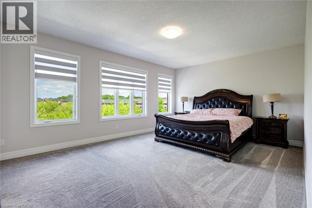 Spacious room with light gray walls and plush gray carpeting - 57 Hollybrook Trail, Kitchener, ON