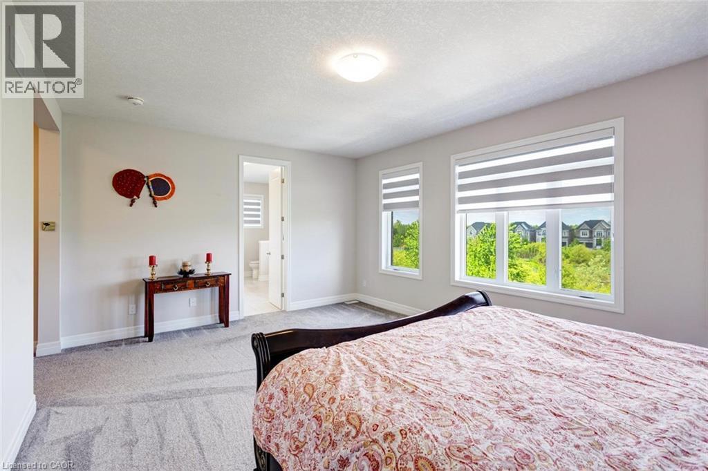 Spacious room featuring multiple windows with integrated blinds, light gray wall paint, and plush carpeting - 57 Hollybrook Trail, Kitchener, ON