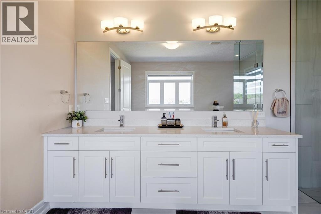 Dual sink vanity with quartz-finish countertop and white shaker-style cabinetry - 57 Hollybrook Trail, Kitchener, ON