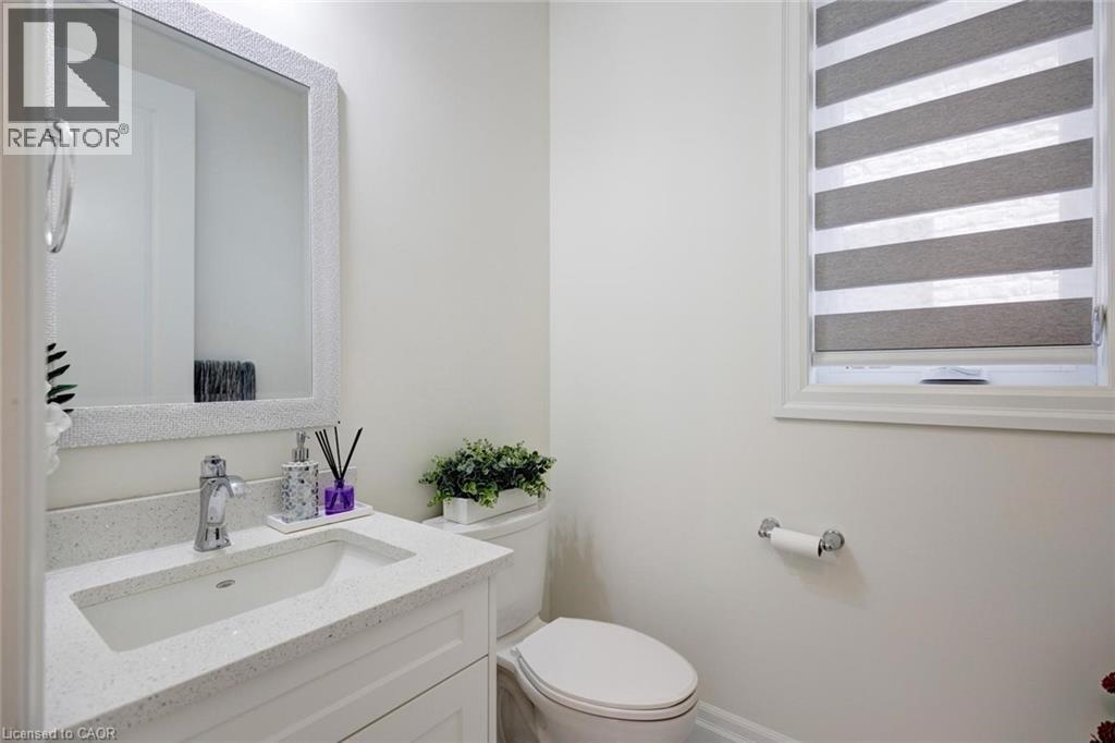 White vanity with an integrated rectangular sink and chrome faucet - 57 Hollybrook Trail, Kitchener, ON