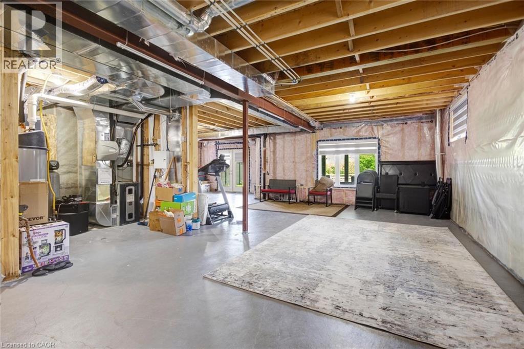 Unfinished basement offering exposed wood joists, structural beams, and concrete flooring - 57 Hollybrook Trail, Kitchener, ON