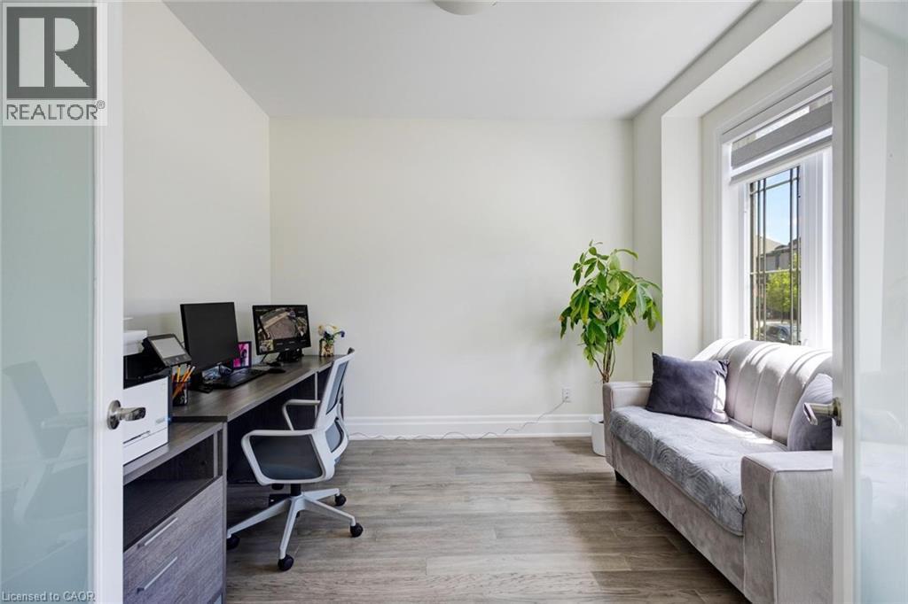 Bright room featuring wood-finish flooring and a white color palette - 57 Hollybrook Trail, Kitchener, ON