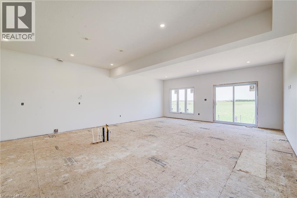 lighting and a dropped ceiling feature - 114 Bedell Drive, Mapleton, ON - Indoor Photo Showing Other Room