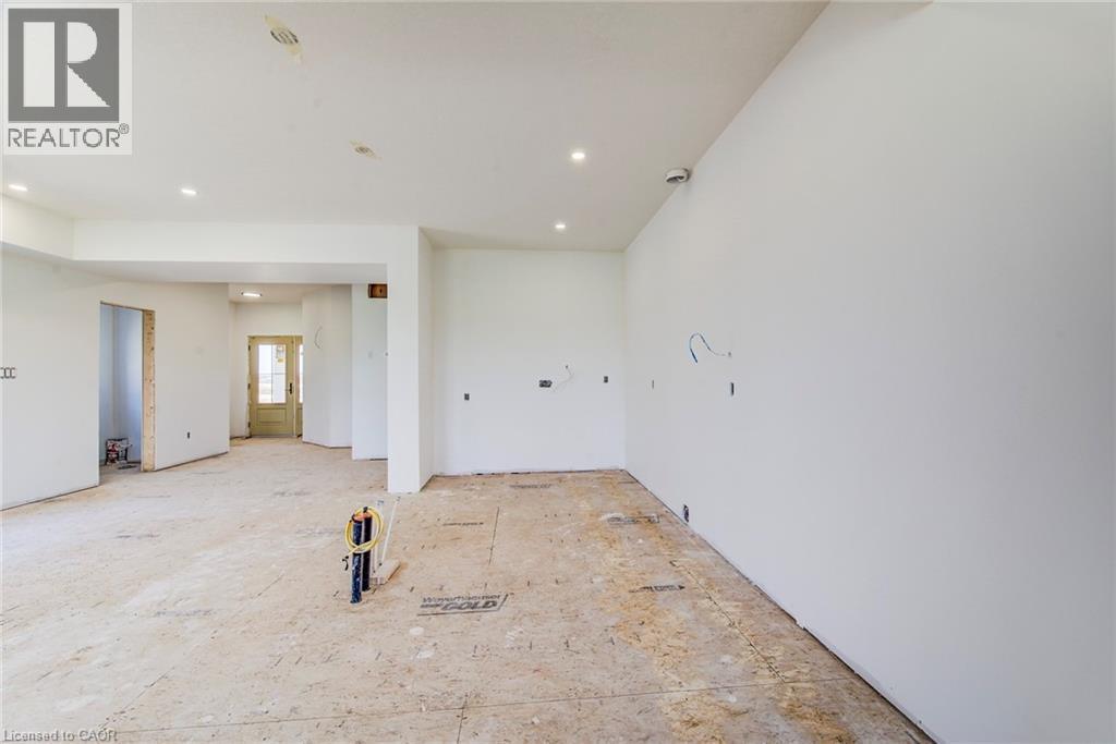 Open concept interior with recessed lighting - 114 Bedell Drive, Mapleton, ON - Indoor Photo Showing Other Room