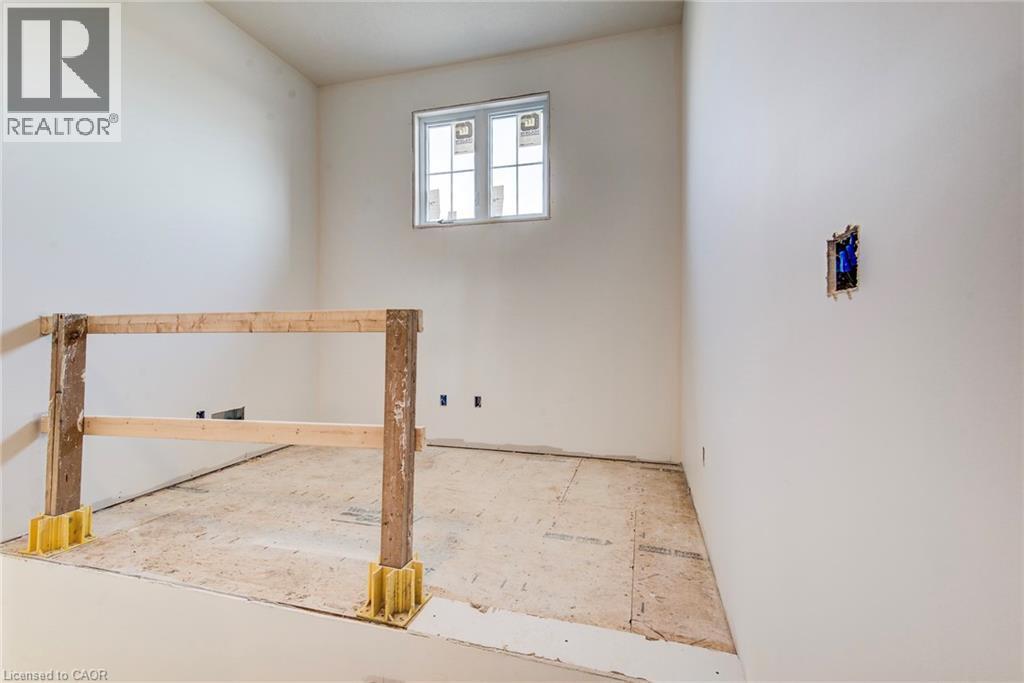 Unfinished interior space featuring a window, temporary wooden railing, and uninstalled flooring - 114 Bedell Drive, Mapleton, ON - Indoor Photo Showing Other Room