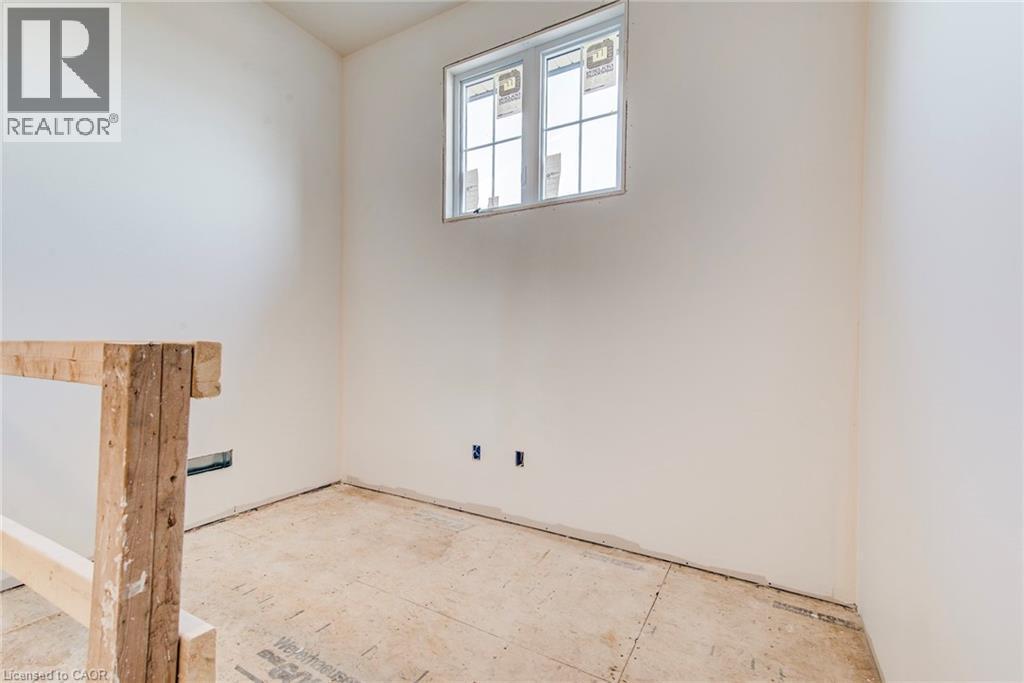 Unfinished room featuring white painted walls and a single window with white framing - 114 Bedell Drive, Mapleton, ON - Indoor Photo Showing Other Room