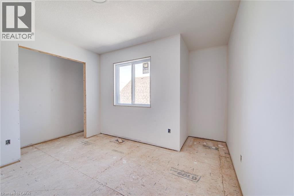 Unfinished room featuring white painted walls, a single-pane window, and exposed subflooring - 114 Bedell Drive, Mapleton, ON - Indoor Photo Showing Other Room