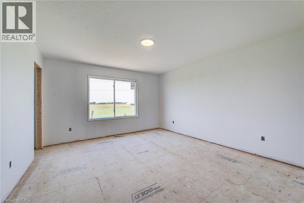 Room featuring a single-pane window, flush-mount ceiling light, white painted walls, and subfloor - 114 Bedell Drive, Mapleton, ON - Indoor Photo Showing Other Room