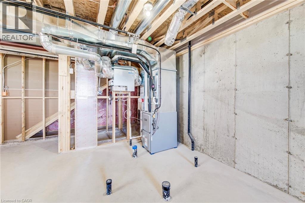 Unfinished basement space featuring exposed concrete walls, wood framing, visible ductwork, and mechanical systems - 114 Bedell Drive, Mapleton, ON - Indoor Photo Showing Basement