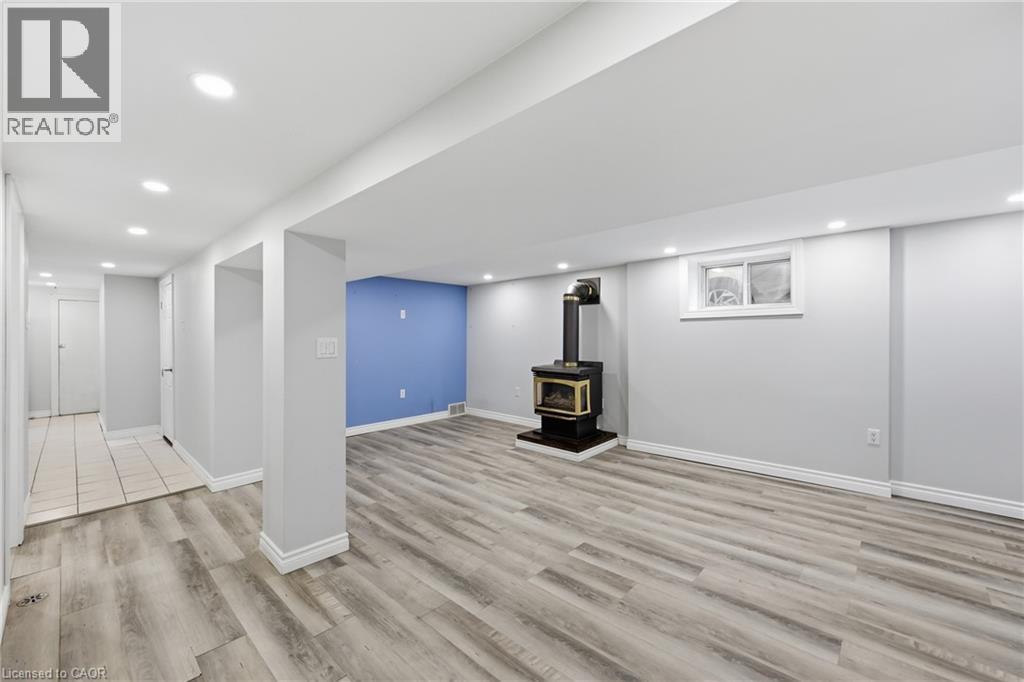 Spacious room featuring wood-finish flooring - 97 Tragina Avenue S, Hamilton, ON