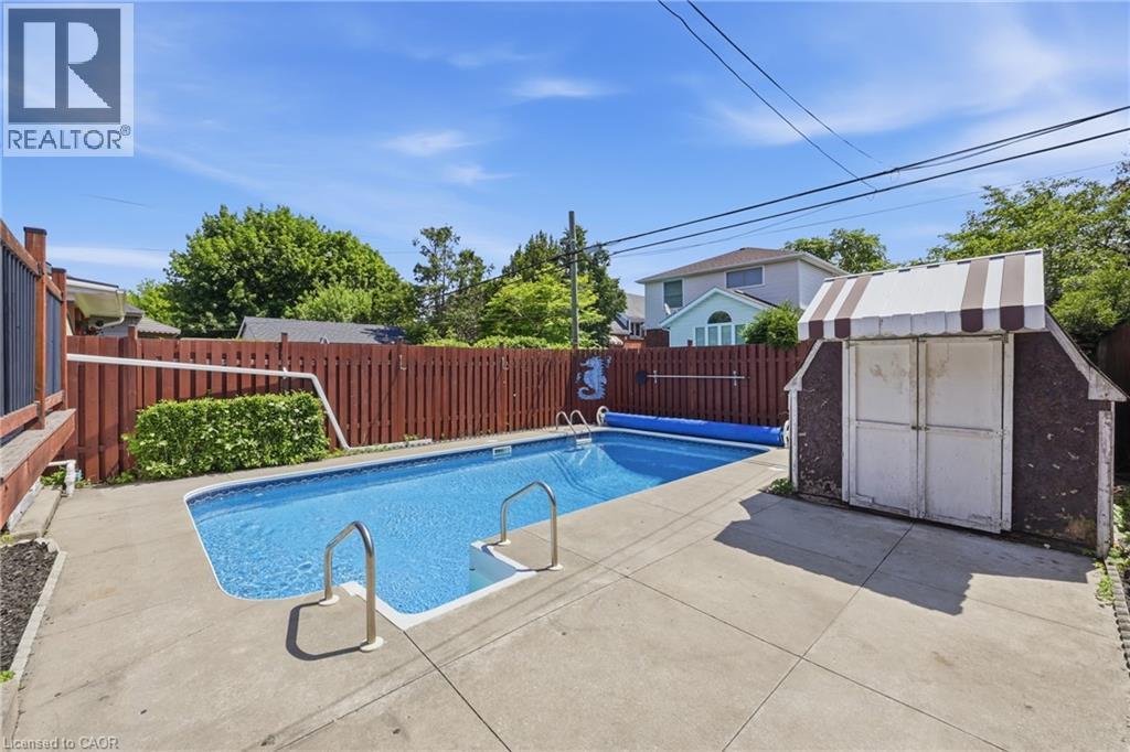 In-ground swimming pool with concrete surround - 97 Tragina Avenue S, Hamilton, ON