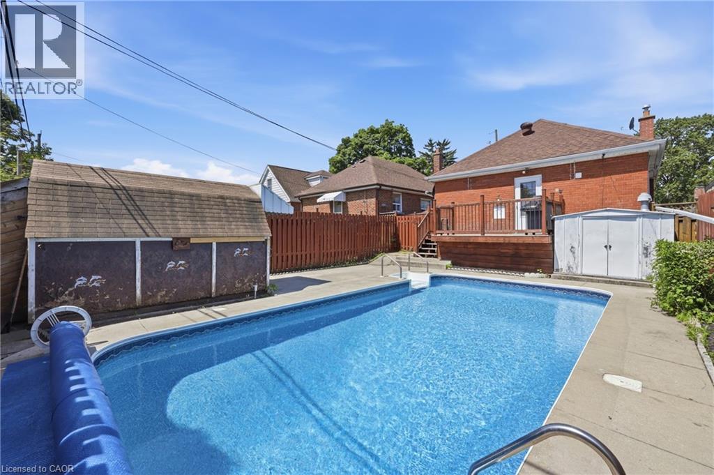 Backyard featuring an in-ground swimming pool with concrete surround - 97 Tragina Avenue S, Hamilton, ON