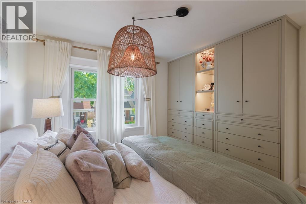 Built-in cabinetry with integrated lighting and varied storage configurations - 41 Park Row N, Hamilton, ON