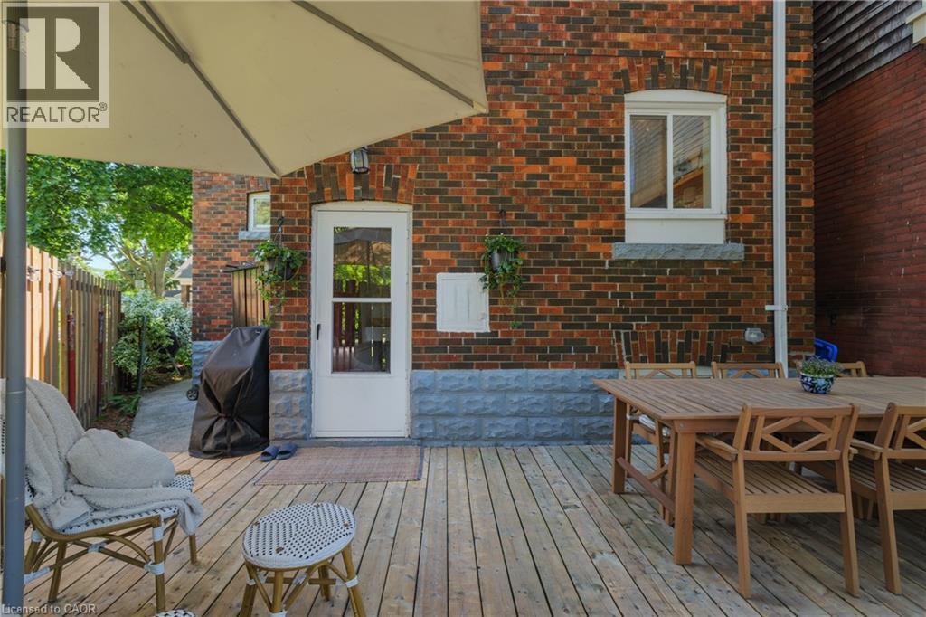 Spacious outdoor wood-finish deck with a brick exterior - 41 Park Row N, Hamilton, ON