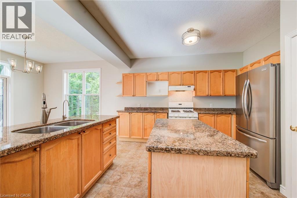 Kitchen is spacious with efficient layout. - 712 Brookmill Place, Waterloo, ON