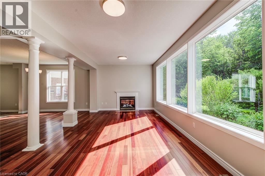 Living room with 3 huge picture windows. - 712 Brookmill Place, Waterloo, ON