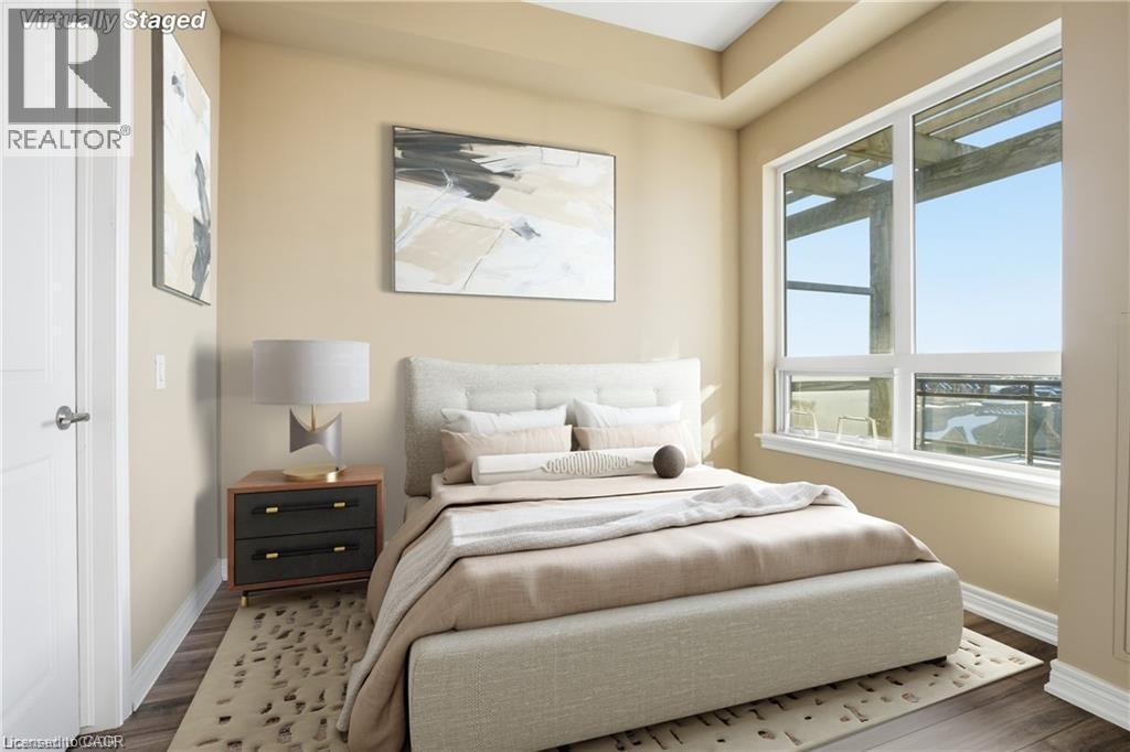 Hardwood-style flooring and light-toned walls define this bedroom, featuring a large window with white framing - 40 Esplanade Lane Unit# 614, Grimsby, ON