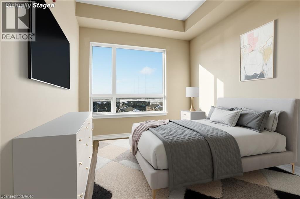 Neutral-toned bedroom featuring a tray ceiling and a large window - 40 Esplanade Lane Unit# 614, Grimsby, ON