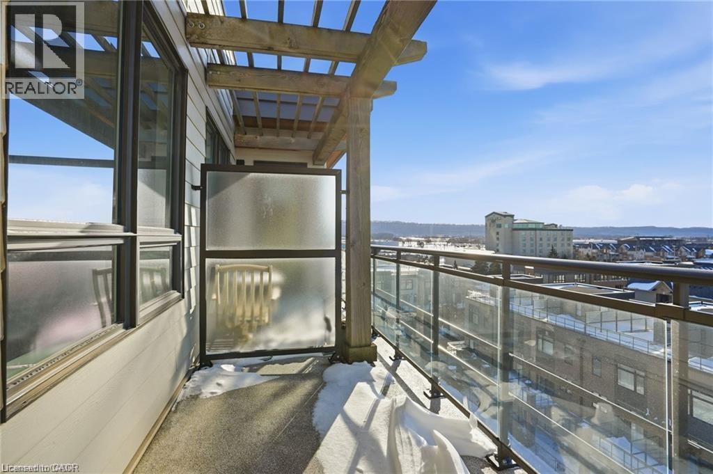 Balcony featuring glass panel railings, a wooden pergola, and a concrete floor - 40 Esplanade Lane Unit# 614, Grimsby, ON