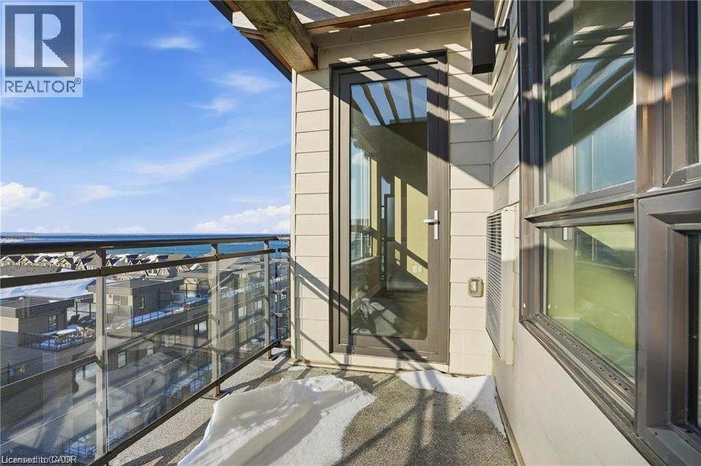 Outdoor balcony featuring a glass and metal railing, a full-lite exterior door, and exterior siding - 40 Esplanade Lane Unit# 614, Grimsby, ON
