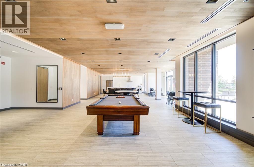 Spacious recreation area featuring a billiards table, full-height windows, recessed ceiling lighting, and tile flooring - 40 Esplanade Lane Unit# 614, Grimsby, ON