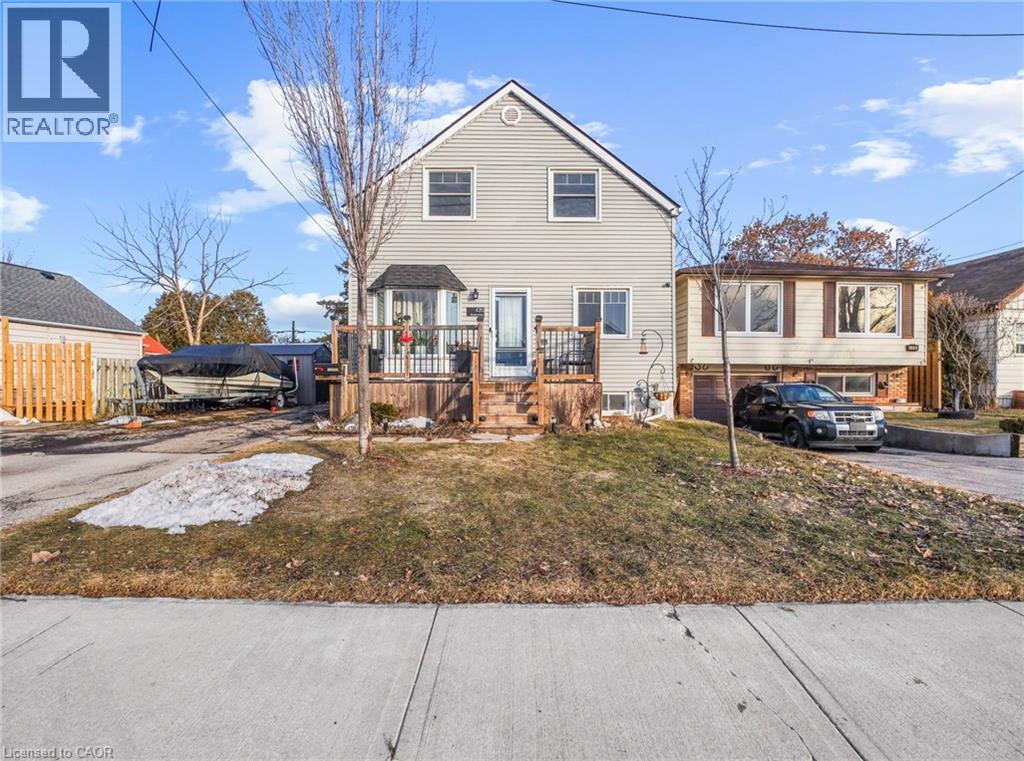 Two-story residence featuring light-toned siding and a gabled roofline - 420 Waverly Street, Hamilton, ON
