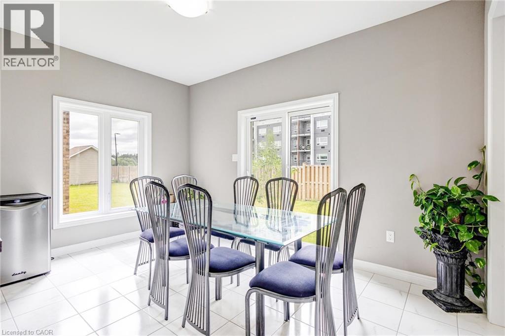 Dining area featuring white square tile flooring and light gray walls - 417 Rivertrail Avenue, Kitchener, ON