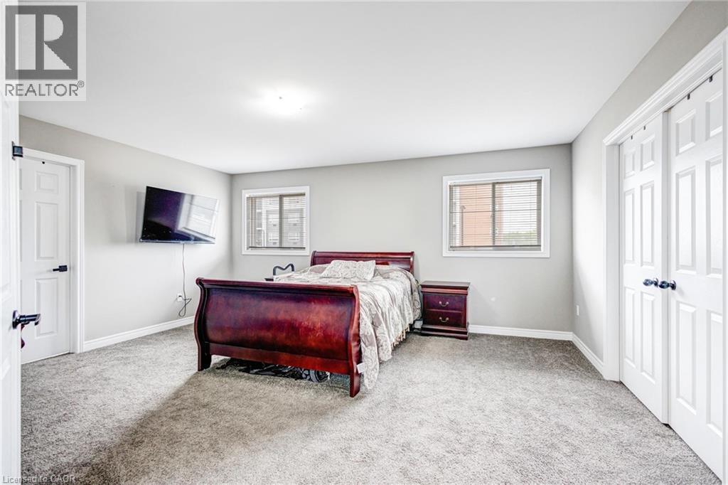 Spacious room with light gray walls and gray carpet flooring - 417 Rivertrail Avenue, Kitchener, ON