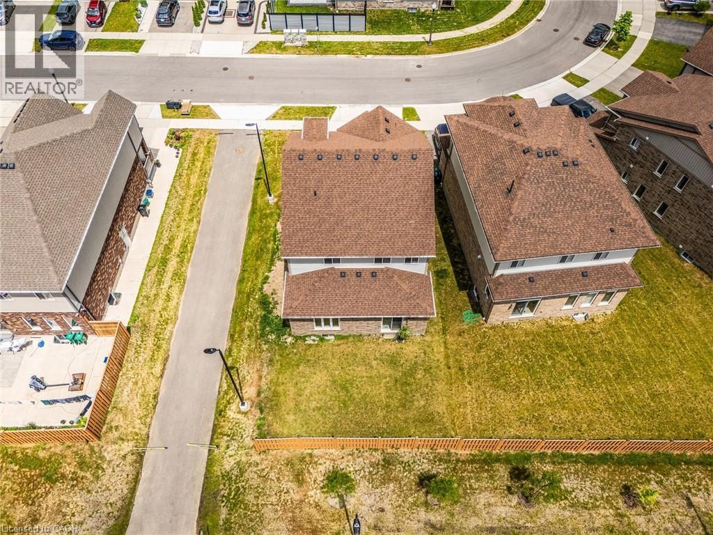Newly constructed residential property featuring a multi-level design, brick and siding exterior, brown shingle roof, and a private rear yard - 417 Rivertrail Avenue, Kitchener, ON