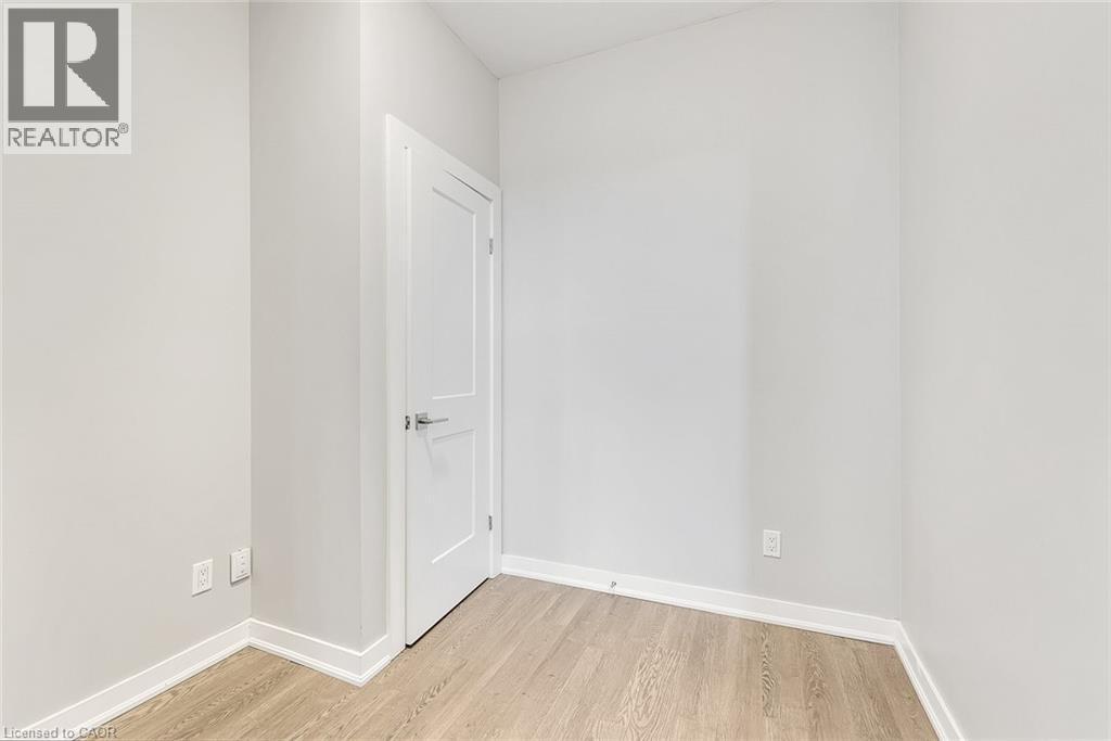 Room featuring light wood-finish flooring, white baseboards, and neutral wall tones - 657 Barton Street E Unit# 302, Hamilton, ON