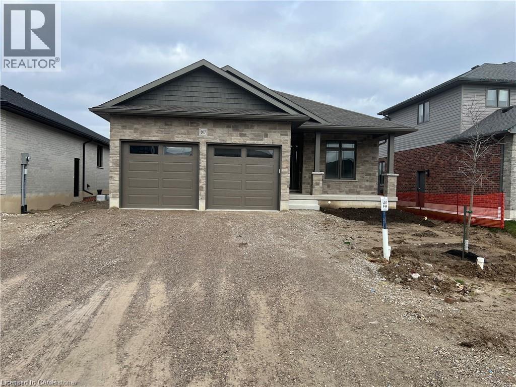 View of front of property with dirt driveway and an attached garage - 207 Arden Crescent Unit# Upper Level, Mitchell, ON