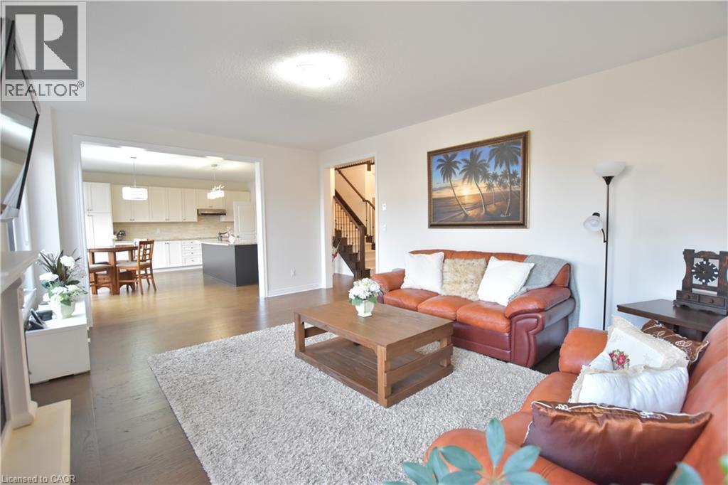 Living room with stairs and dark wood-style flooring - 512 Terrington Crescent, Kitchener, ON
