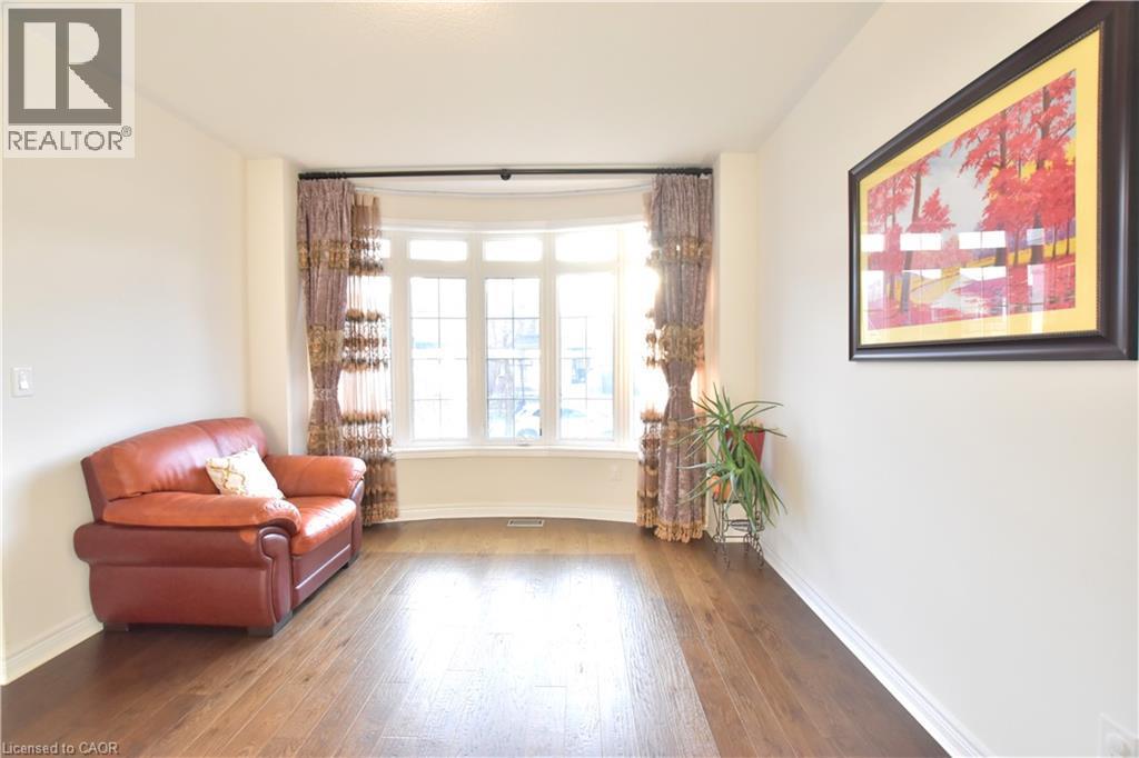 Sitting room with hardwood / wood-style flooring and baseboards - 512 Terrington Crescent, Kitchener, ON