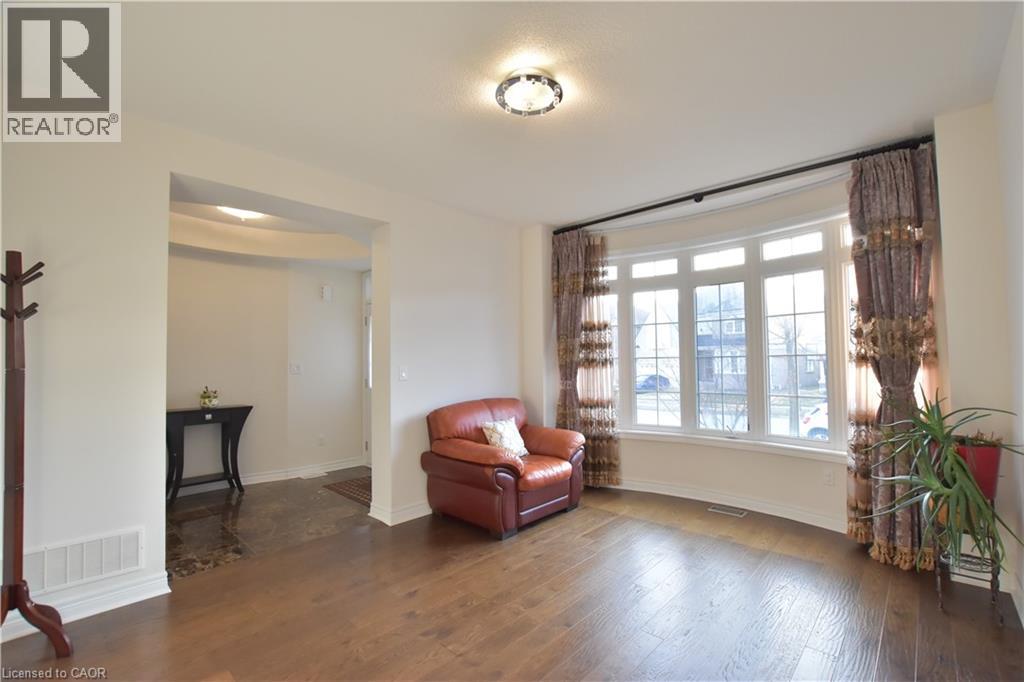 Living area with dark wood-style floors and baseboards - 512 Terrington Crescent, Kitchener, ON