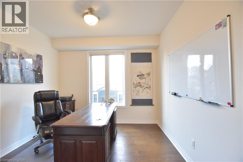 Office area with dark wood finished floors and baseboards - 512 Terrington Crescent, Kitchener, ON