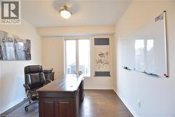 Office area with dark wood finished floors and baseboards -