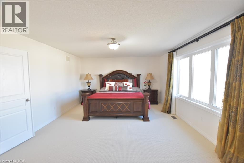 Bedroom with light carpet and baseboards - 512 Terrington Crescent, Kitchener, ON