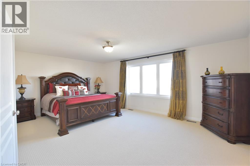 Bedroom with light carpet and baseboards - 512 Terrington Crescent, Kitchener, ON