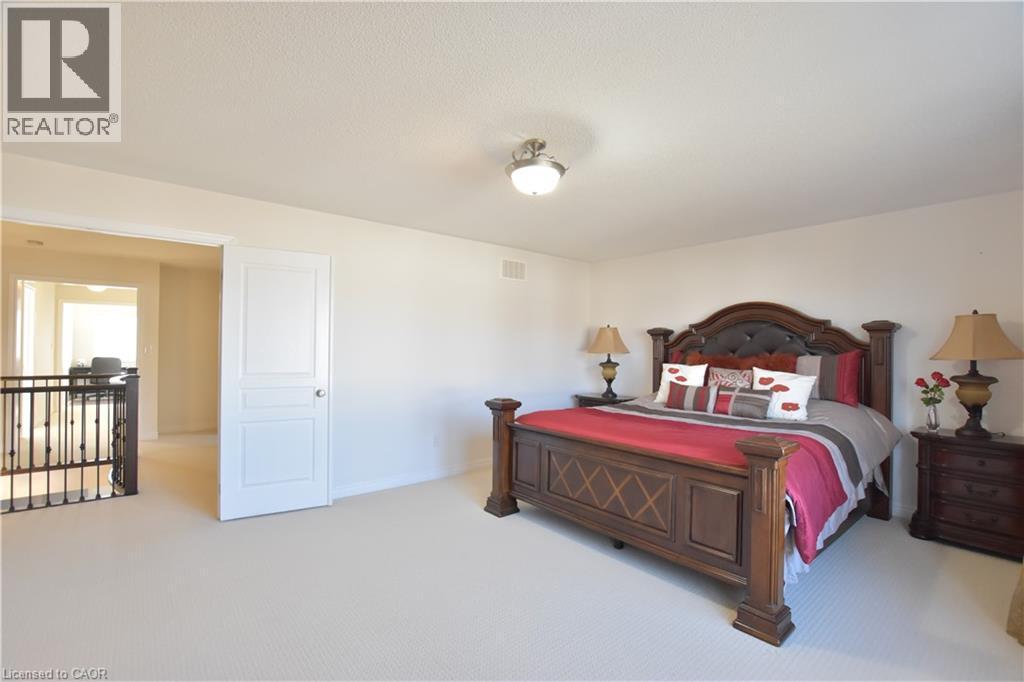 Bedroom featuring light carpet and baseboards - 512 Terrington Crescent, Kitchener, ON