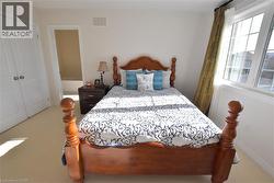 Carpeted bedroom featuring a closet -