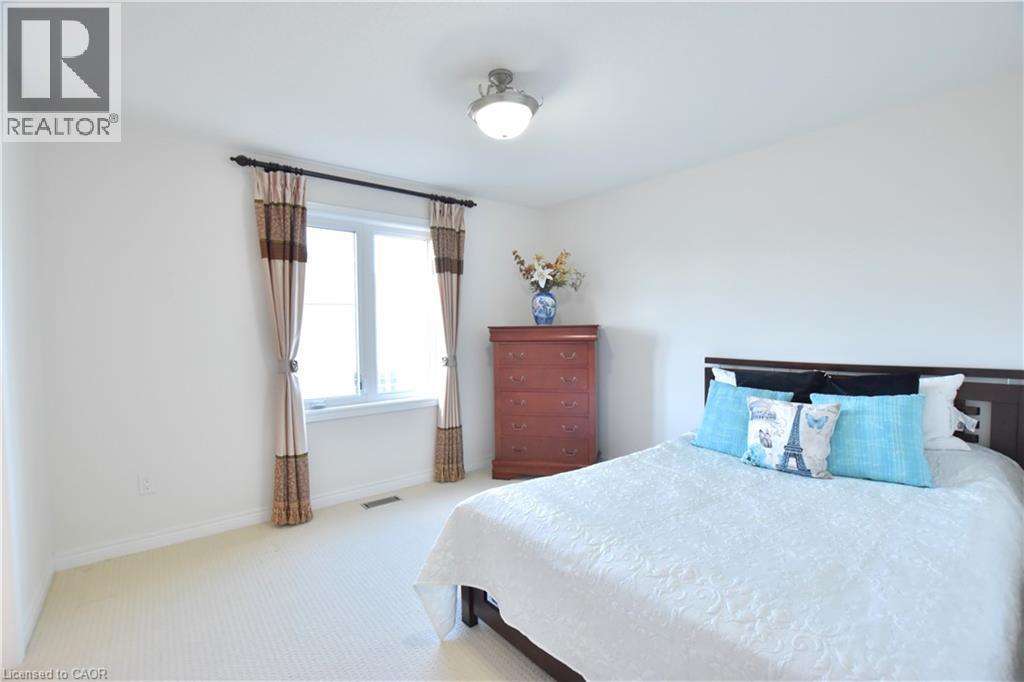 Bedroom with light carpet and baseboards - 512 Terrington Crescent, Kitchener, ON