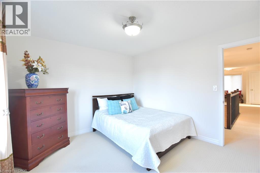 Bedroom featuring light colored carpet and baseboards - 512 Terrington Crescent, Kitchener, ON