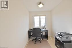 Office space featuring baseboards and light colored carpet -