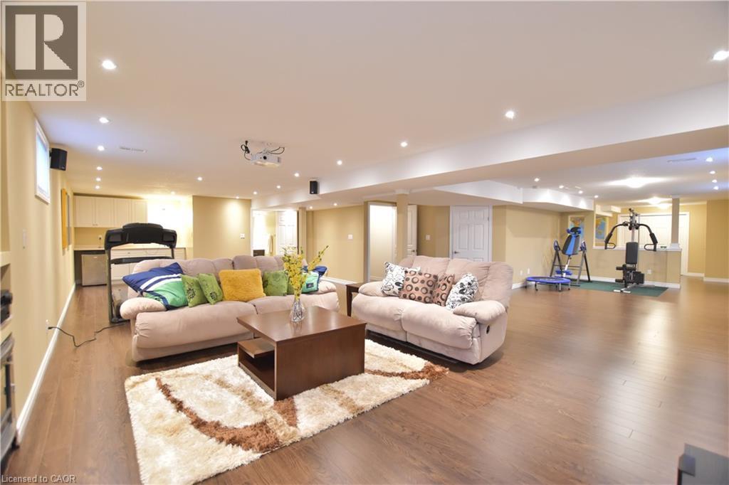 Living room featuring wood finished floors and recessed lighting - 512 Terrington Crescent, Kitchener, ON