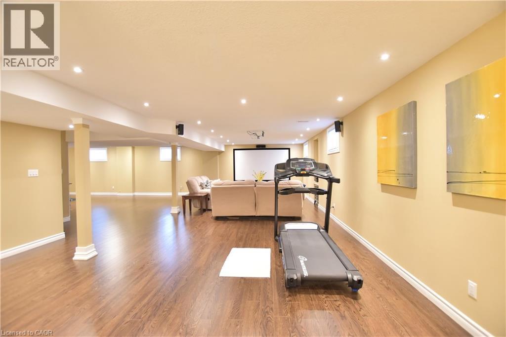 Workout room with light wood-style floors and recessed lighting - 512 Terrington Crescent, Kitchener, ON